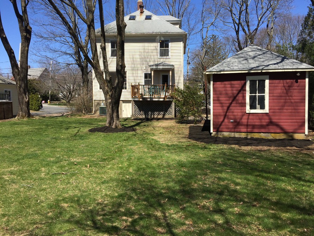 80 Spring Road Needham, MA 02494 - Photo 23 of 25 a front view of a house with a garden
