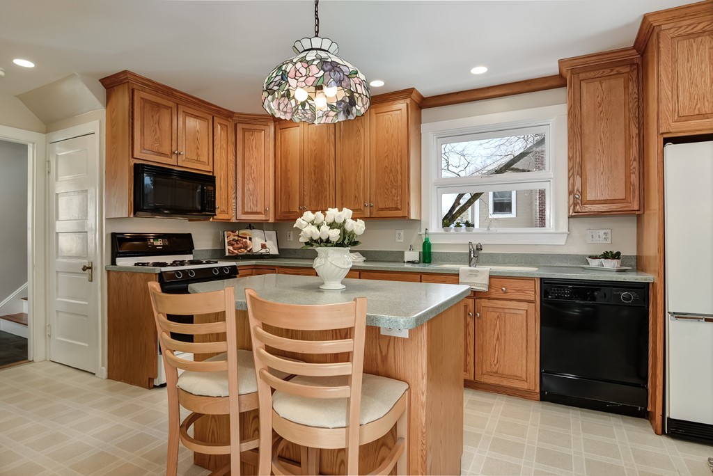 80 Spring Road Needham, MA 02494 - Photo 3 of 25 a kitchen with a sink stove and microwave