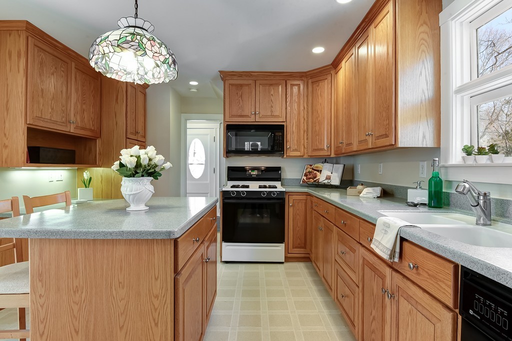 80 Spring Road Needham, MA 02494 - Photo 4 of 25 a kitchen with stainless steel appliances granite countertop a stove a sink dishwasher and a microwave oven
