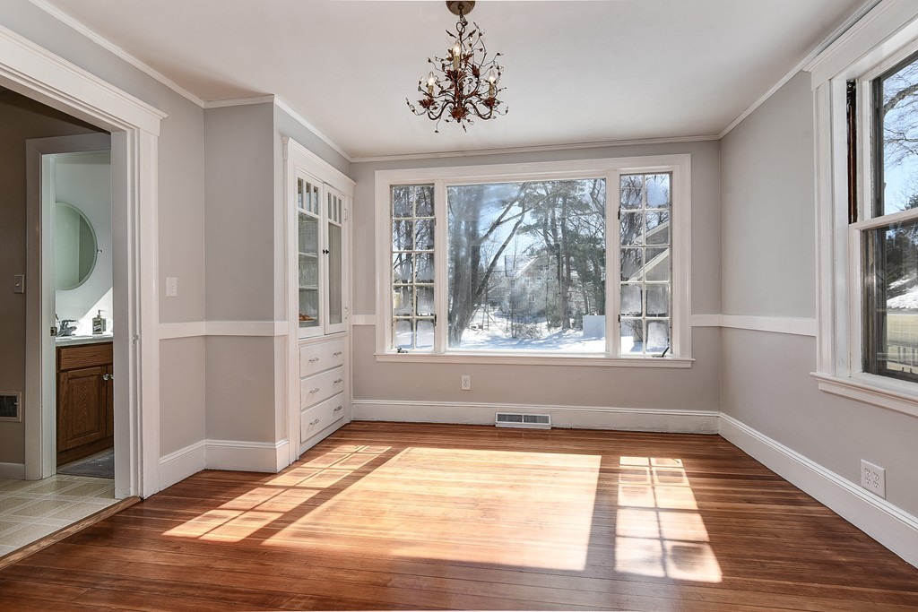 80 Spring Road Needham, MA 02494 - Photo 8 of 25 a view of an empty room with a window and wooden floor