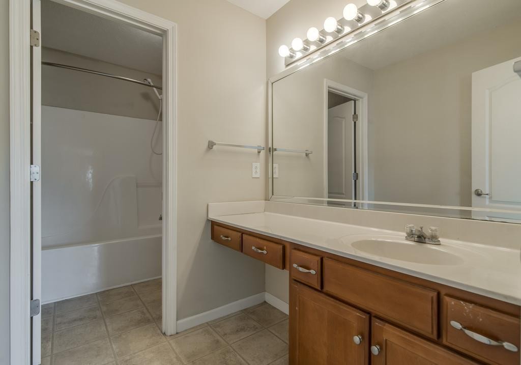 284 Meigs Drive, Unit E39 Murfreesboro, TN 37128 - Photo 11 of 15 a bathroom with a sink and a mirror