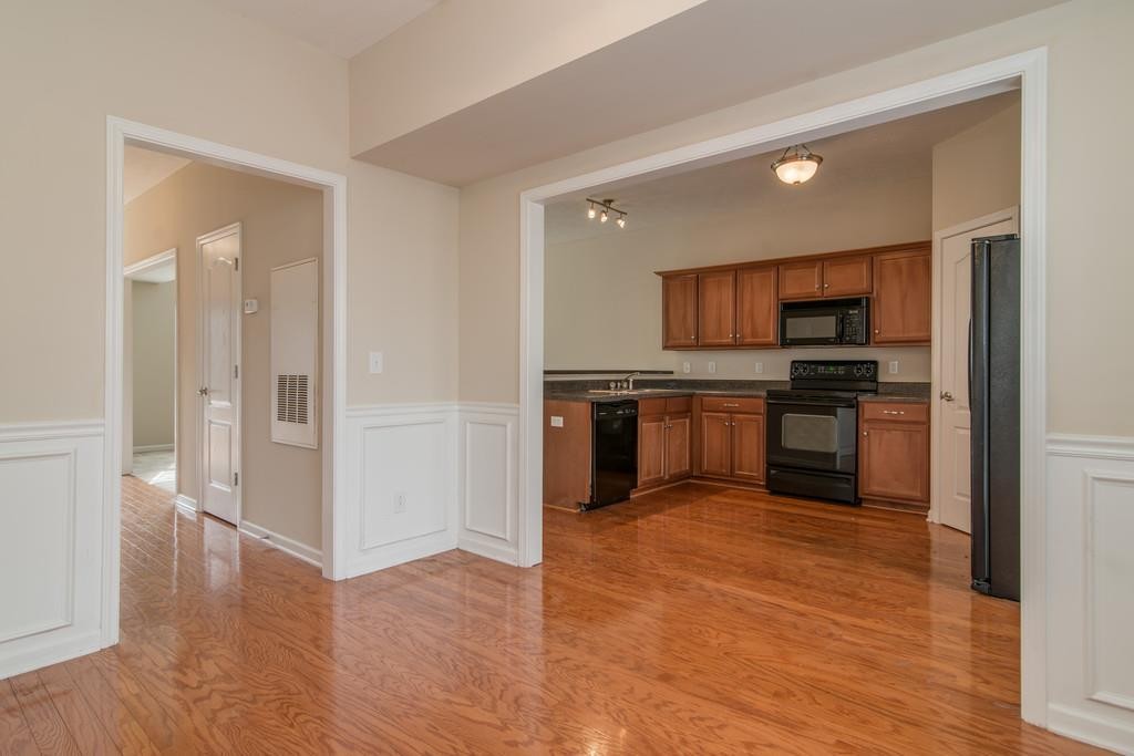 284 Meigs Drive, Unit E39 Murfreesboro, TN 37128 - Photo 8 of 15 a kitchen with wooden floors and stainless steel appliances