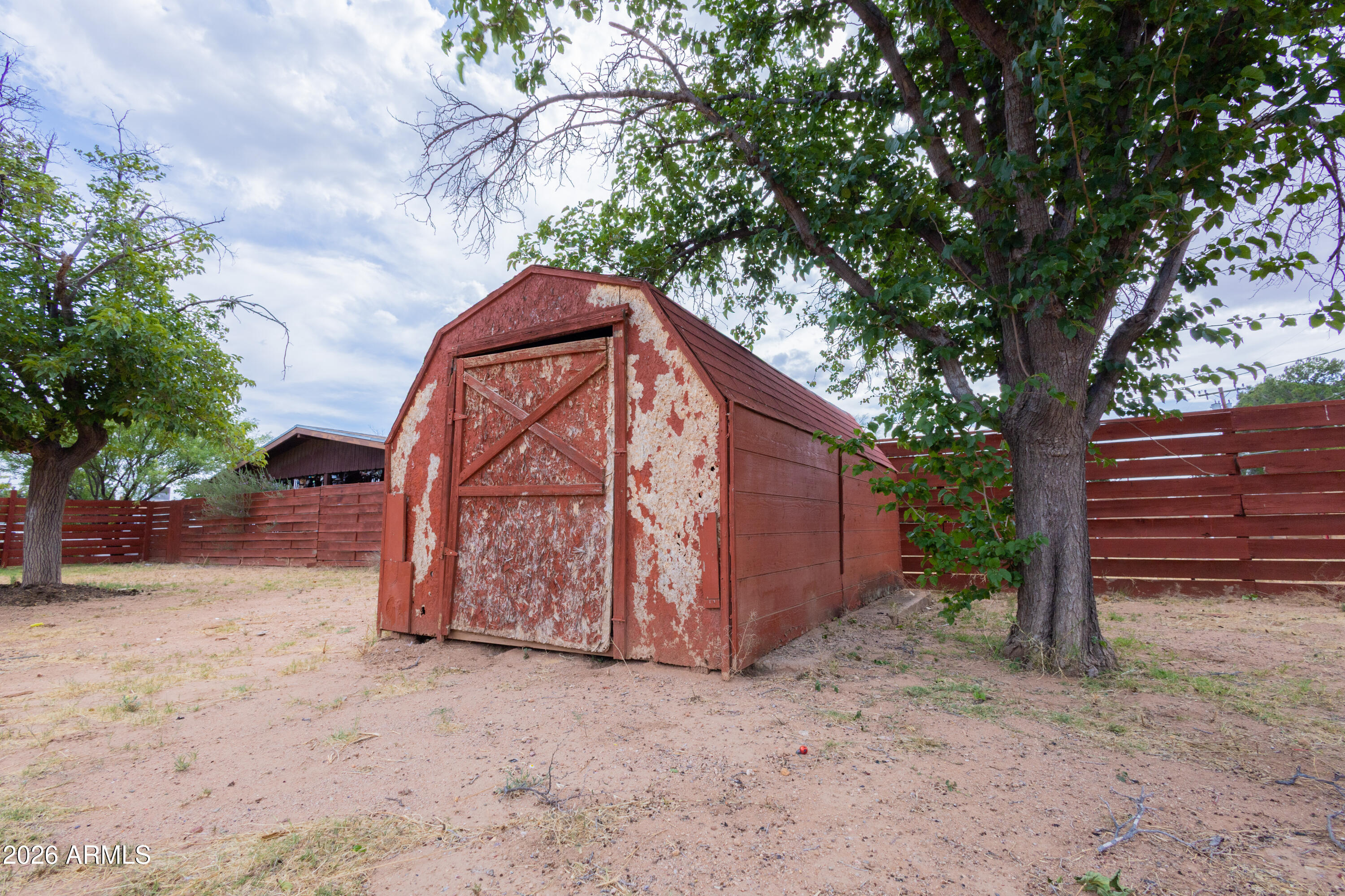 1626 11th Street Douglas, AZ 85607 - Photo 28 of 30 a view of backyard with large trees and wooden fence