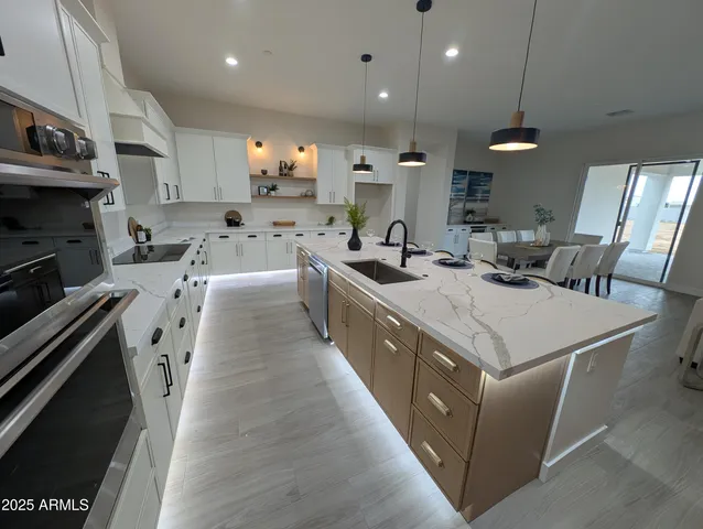 a large kitchen with stainless steel appliances lots of counter space