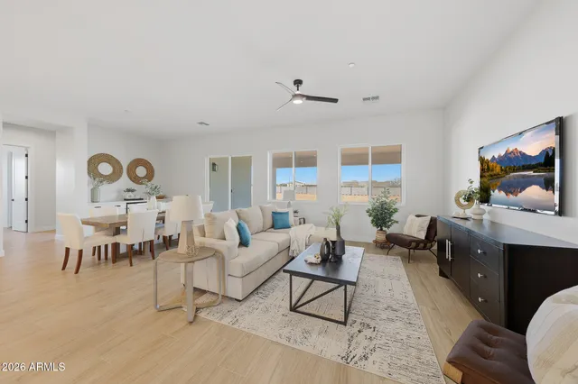 a kitchen with stainless steel appliances kitchen island a table and chairs in it