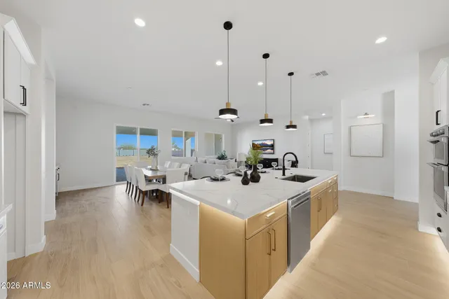 a view of a room with wooden floor and a hallway
