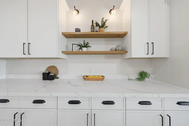 a view of empty room with wooden floor and ceiling fan