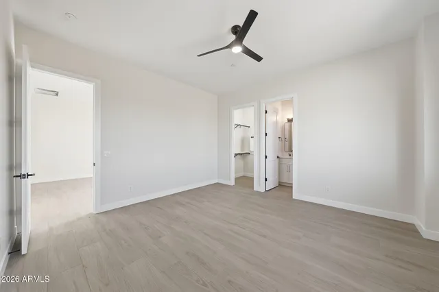 a bathroom with double vanity sinks and a shower