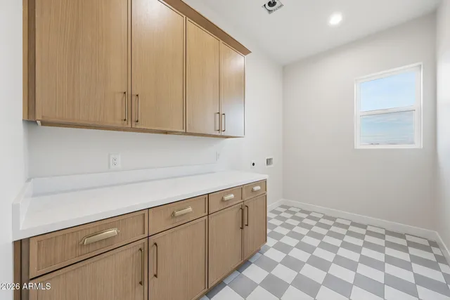 a view of an empty room with wooden floor and a ceiling fan
