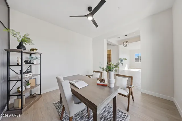 a living room with furniture white walls and a chandelier
