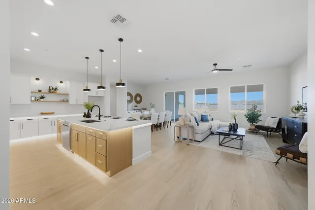 a living room with furniture and view of kitchen