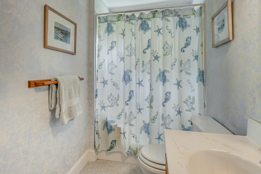 240 Robbins Hill Road Brewster, MA 02631 - Photo 21 of 35 a bathroom with a toilet and a shower curtain