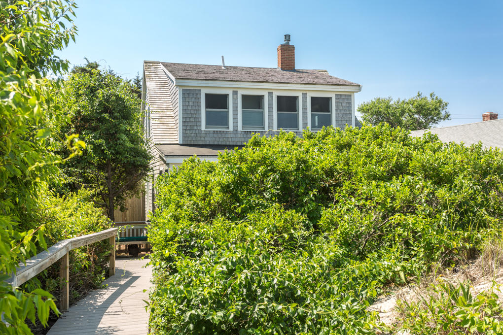 240 Robbins Hill Road Brewster, MA 02631 - Photo 3 of 35 a house view with a garden space