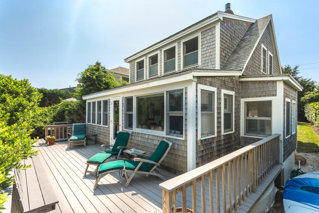 240 Robbins Hill Road Brewster, MA 02631 - Photo 5 of 35 a view of house with a chairs and table in a balcony