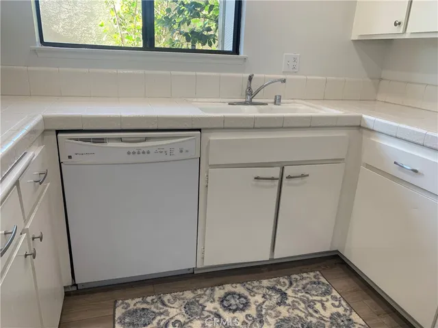 a room with washing machine and a sink