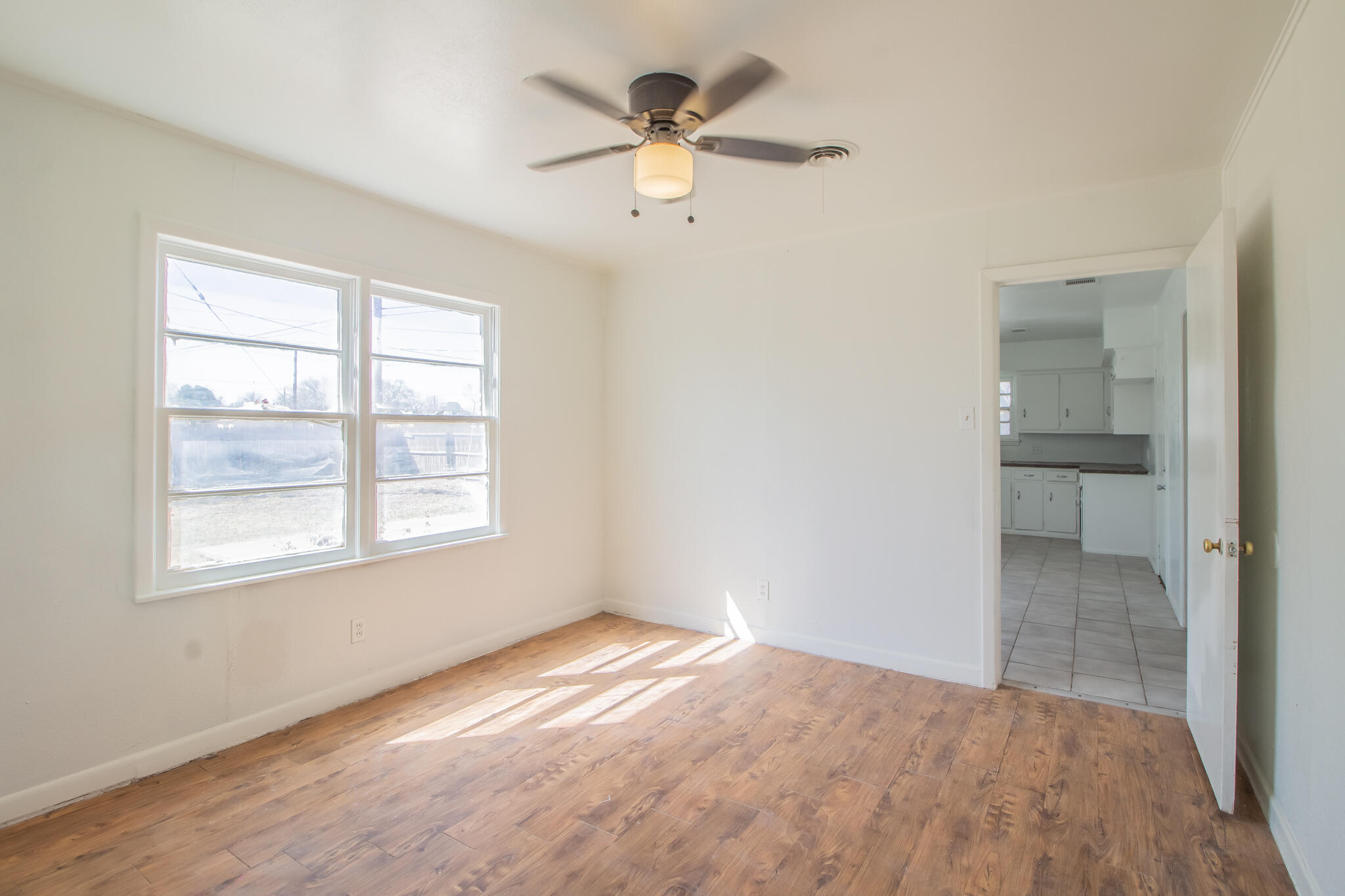 4621 35th Street Lubbock, TX 79414 - Photo 11 of 19 wooden floor in an empty room with a window