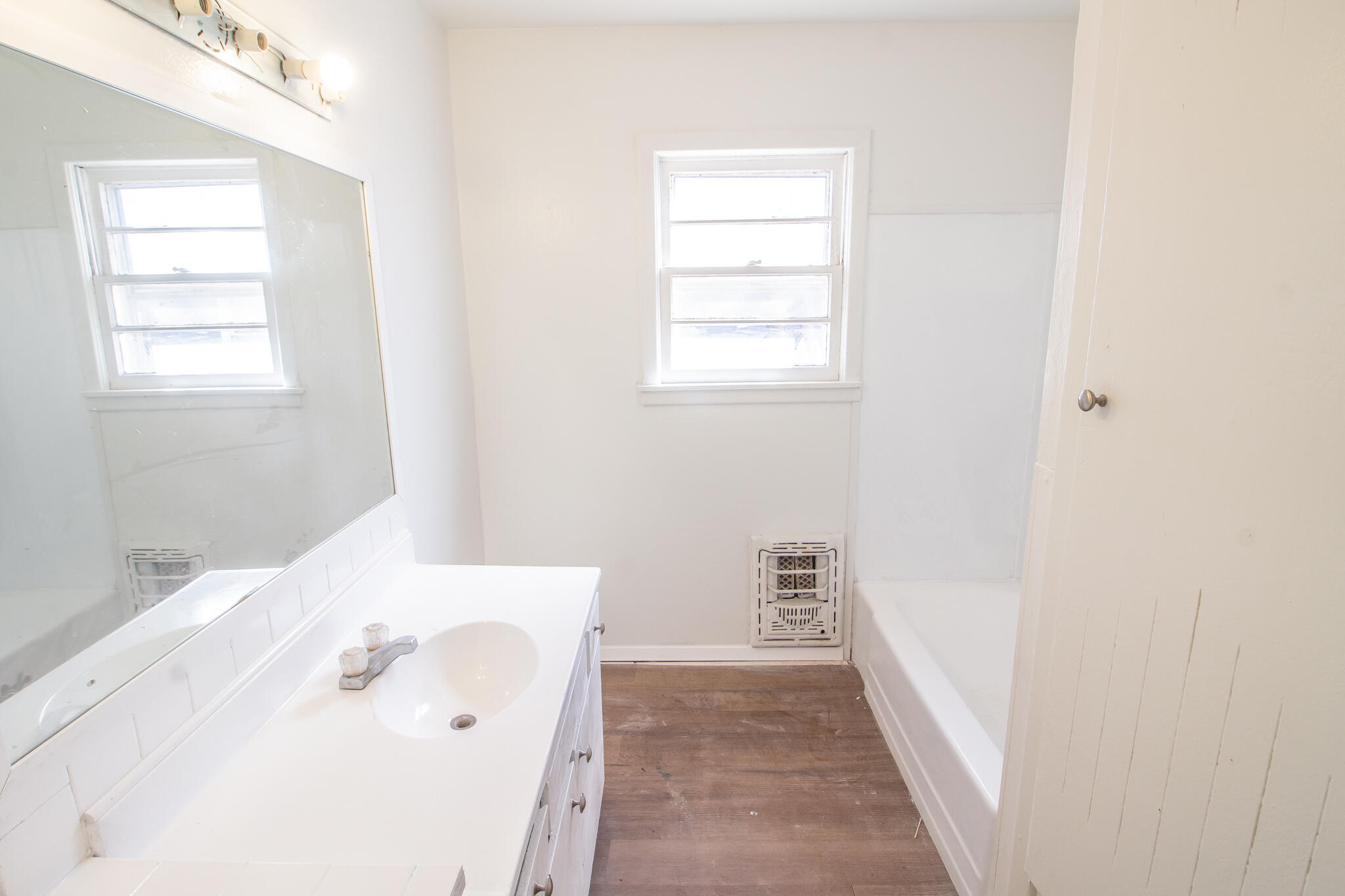 4621 35th Street Lubbock, TX 79414 - Photo 14 of 19 a bathroom with a bathtub sink and window