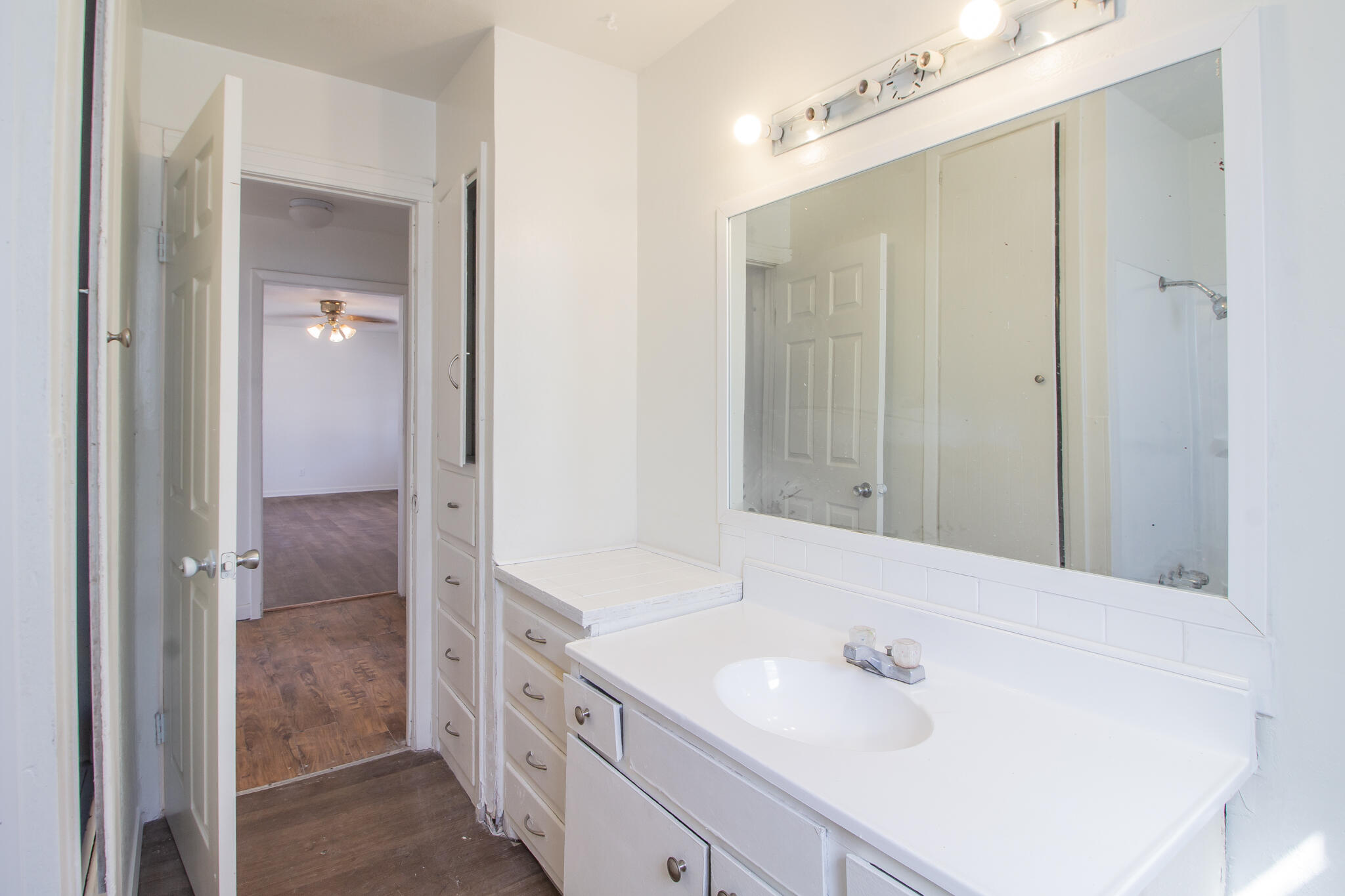 4621 35th Street Lubbock, TX 79414 - Photo 15 of 19 a bathroom with a sink a mirror and a shower