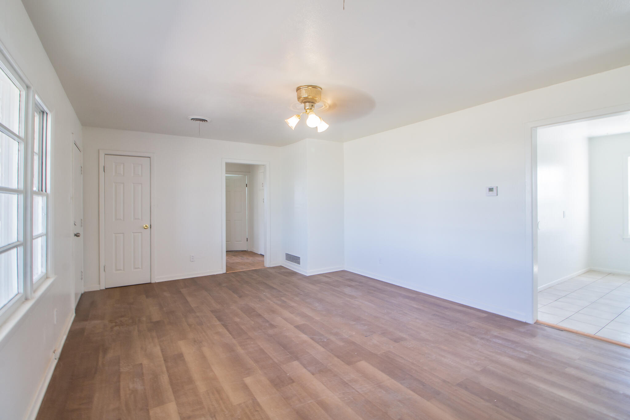 4621 35th Street Lubbock, TX 79414 - Photo 5 of 19 a view of empty room with wooden floor and fan
