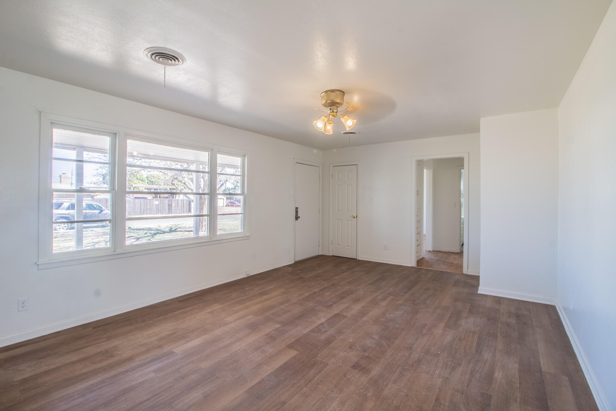 4621 35th Street Lubbock, TX 79414 - Photo 6 of 19 wooden floor in an empty room with a window