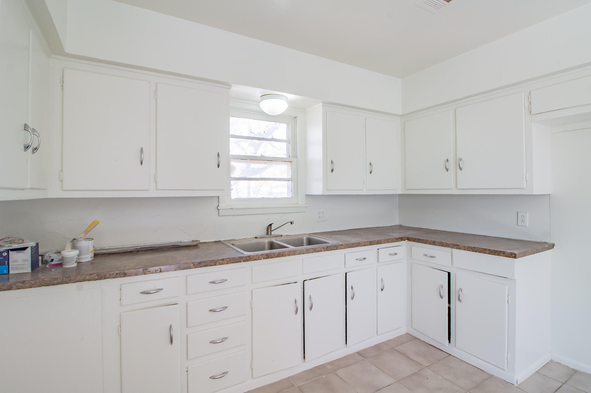 4621 35th Street Lubbock, TX 79414 - Photo 8 of 19 a kitchen with white cabinets appliances and a sink