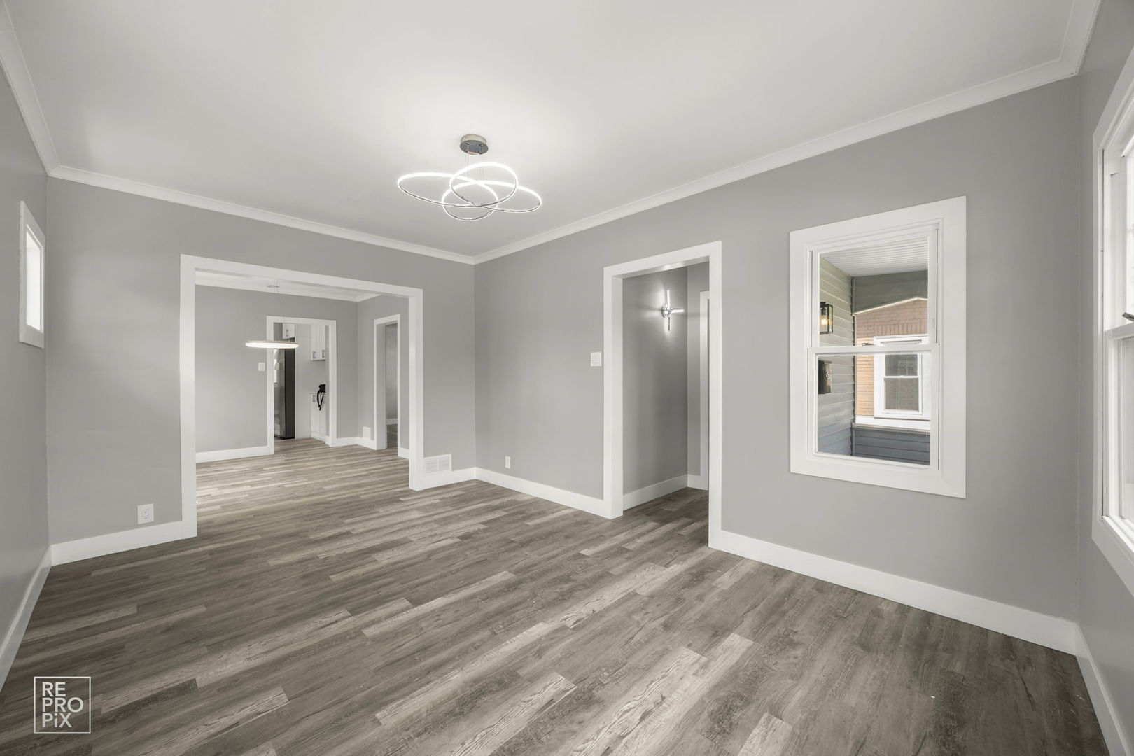 628 South 19th Avenue Maywood, IL 60153 - Photo 2 of 10 a view of an empty room with wooden floor and a window