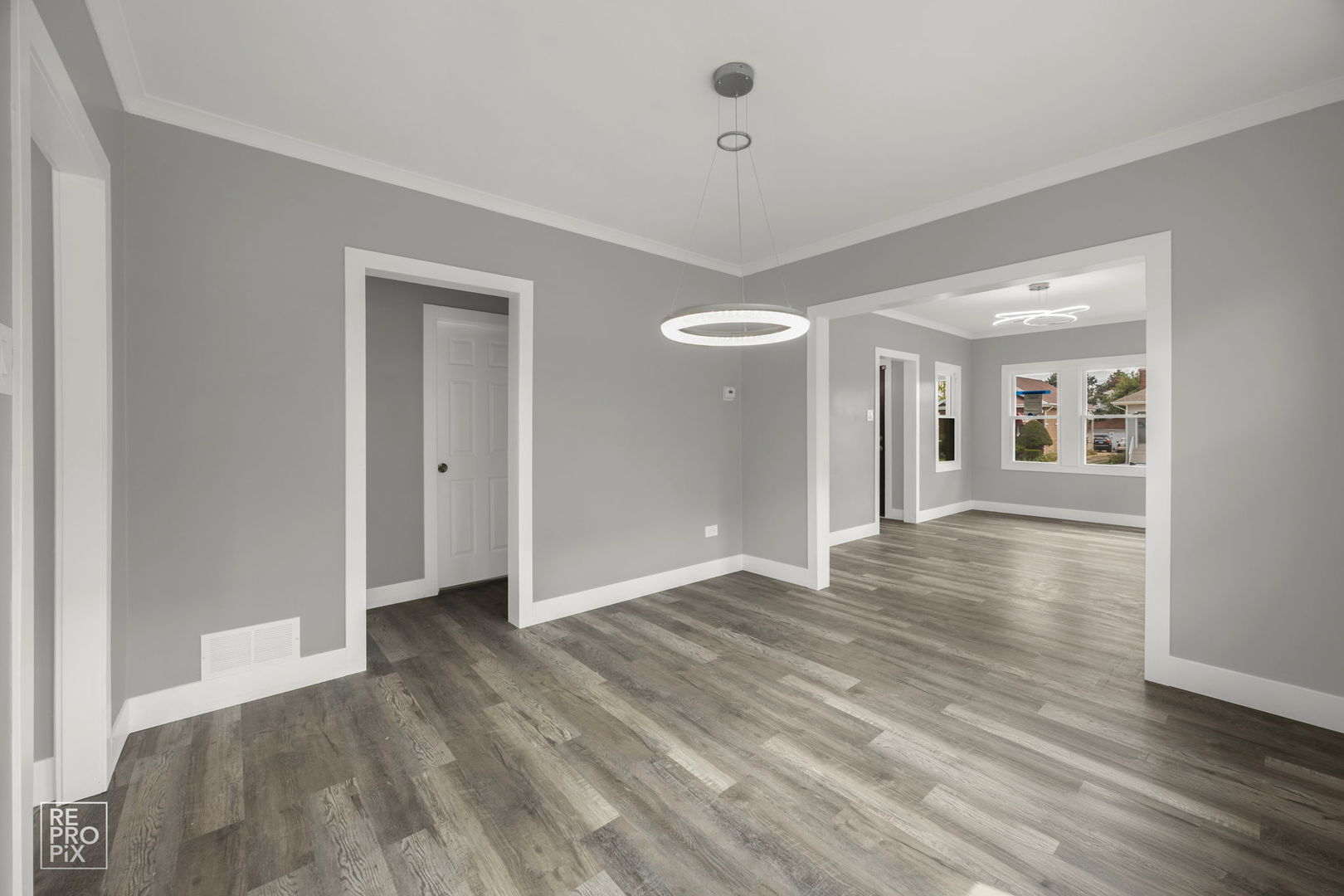 628 South 19th Avenue Maywood, IL 60153 - Photo 3 of 10 a view of an empty room with wooden floor and a window