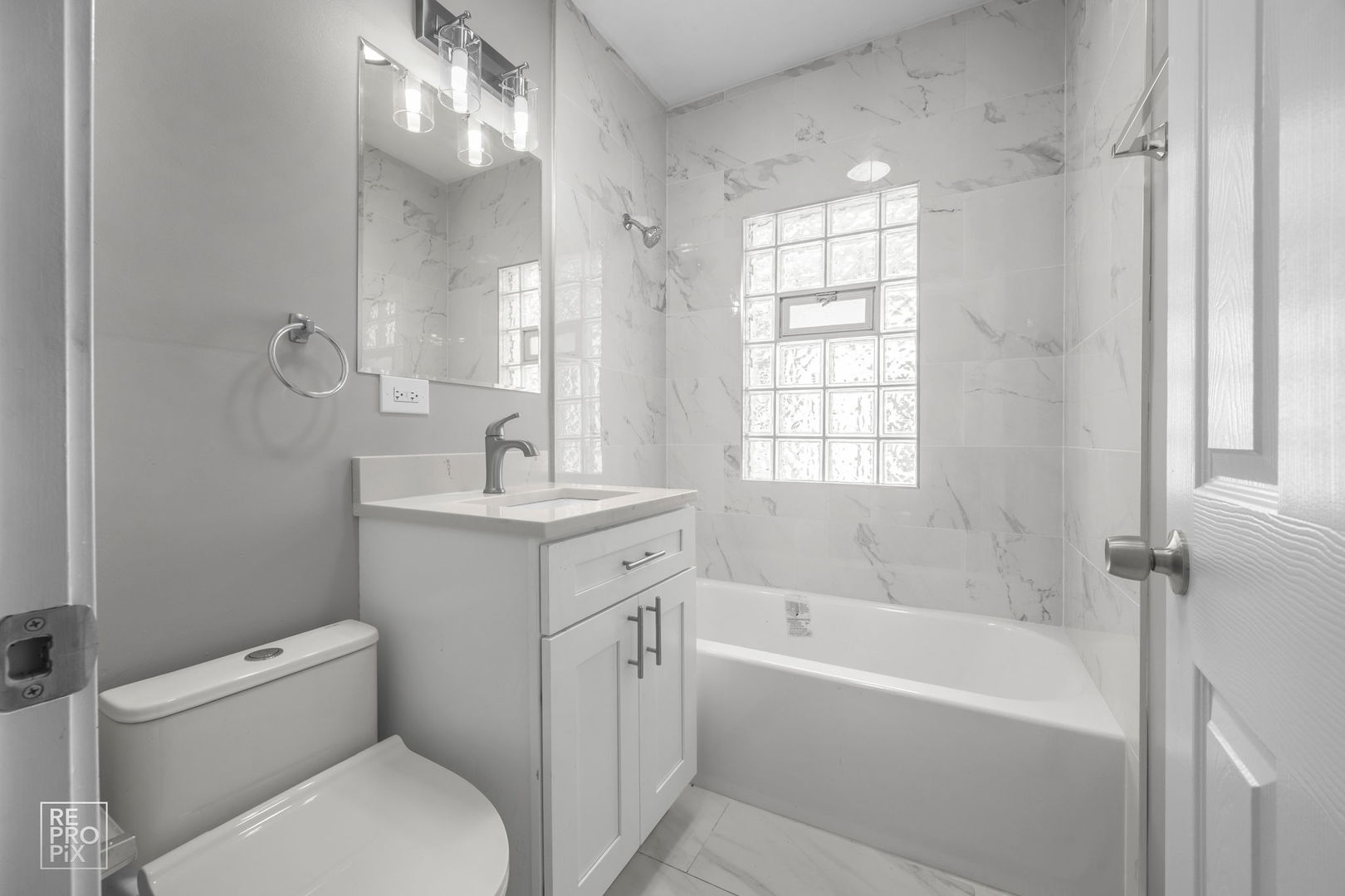 628 South 19th Avenue Maywood, IL 60153 - Photo 9 of 10 a bathroom with a granite countertop toilet a sink and a bathtub