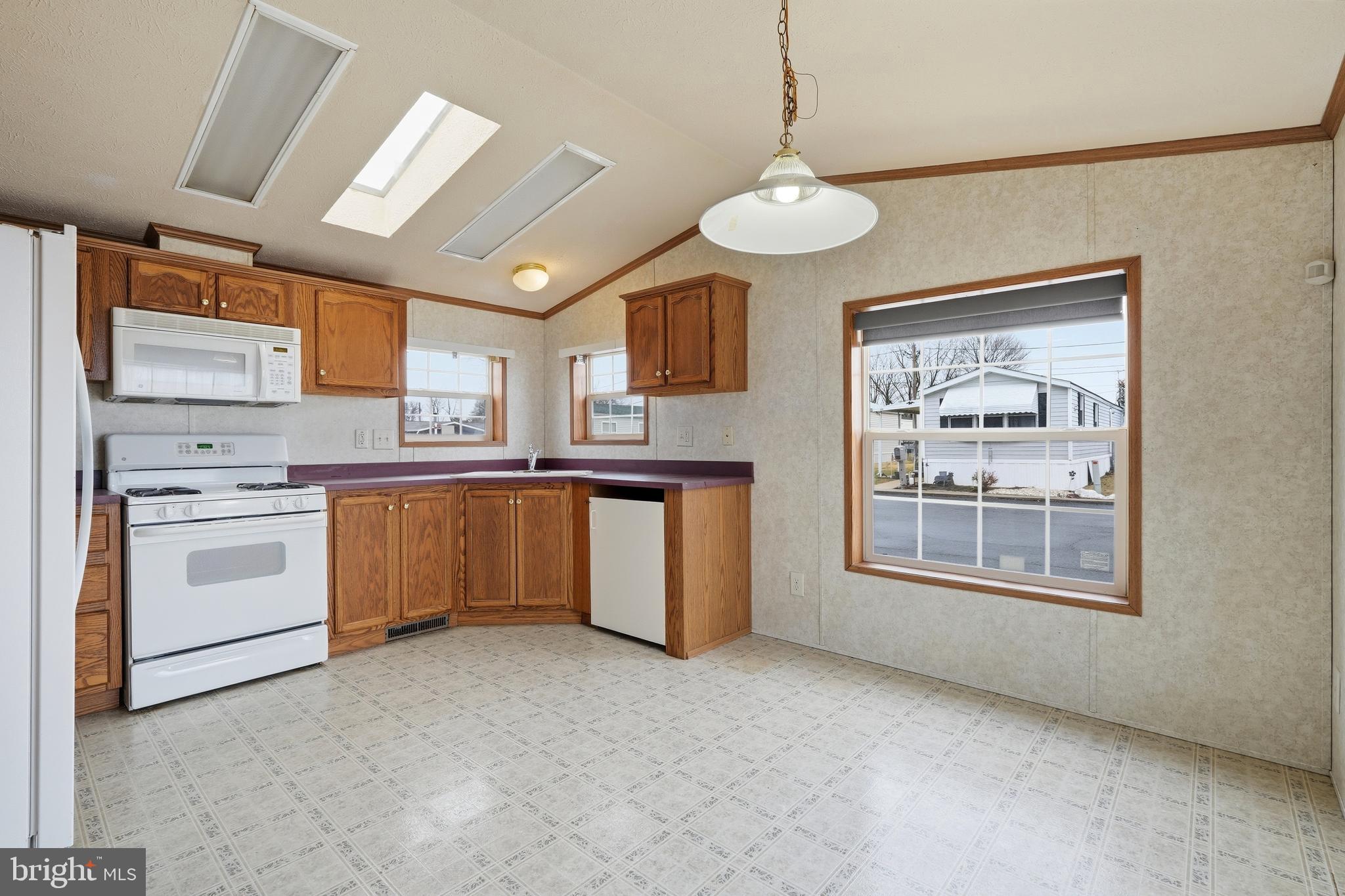 507 Canter Road Wilmington, DE 19810 - Photo 4 of 15 a kitchen with a stove a sink and a refrigerator