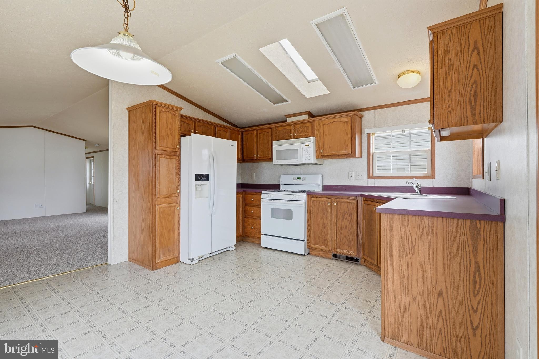 507 Canter Road Wilmington, DE 19810 - Photo 5 of 15 a kitchen with a refrigerator a sink and a stove