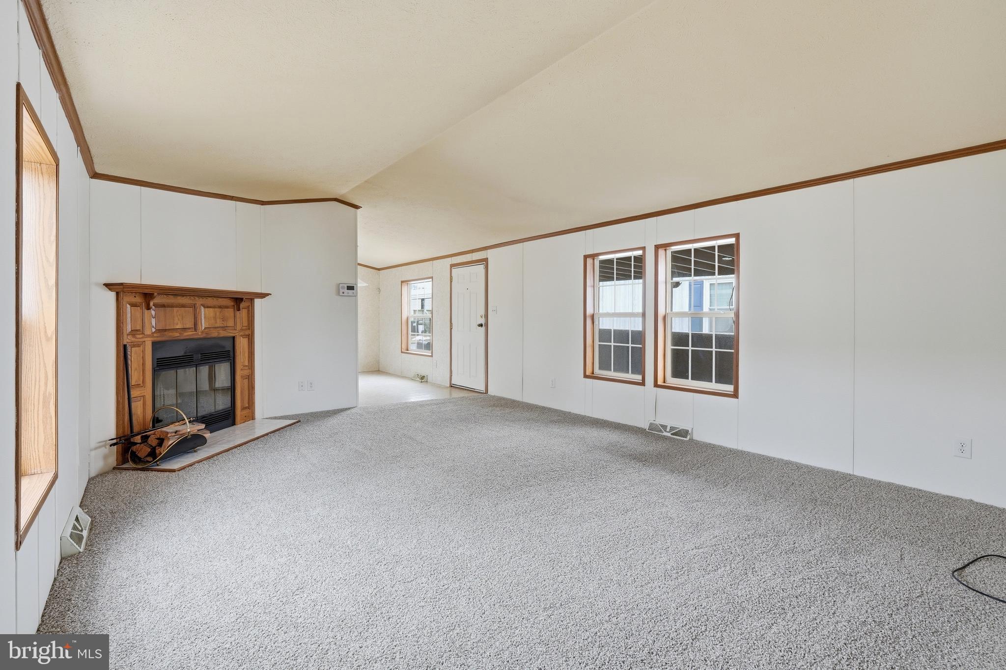 507 Canter Road Wilmington, DE 19810 - Photo 7 of 15 a view of an empty room with a fireplace