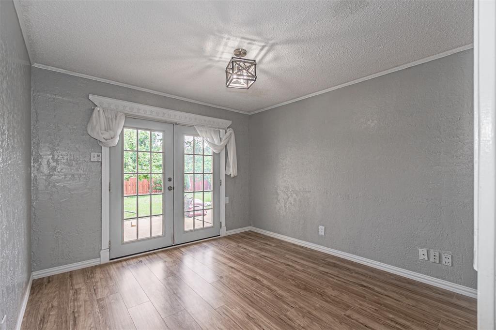 2435 Old Mill Road Dallas, TX 75287 - Photo 12 of 30 a view of an empty room with a window and wooden floor