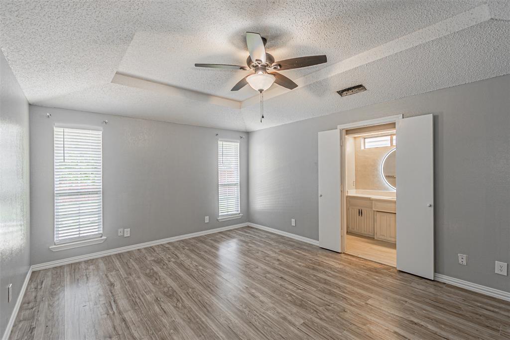 2435 Old Mill Road Dallas, TX 75287 - Photo 25 of 30 wooden floor in an empty room with a window