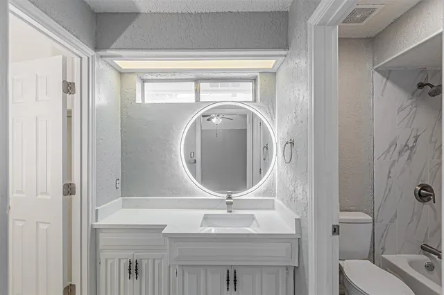 a bathroom with a shower a toilet and sink