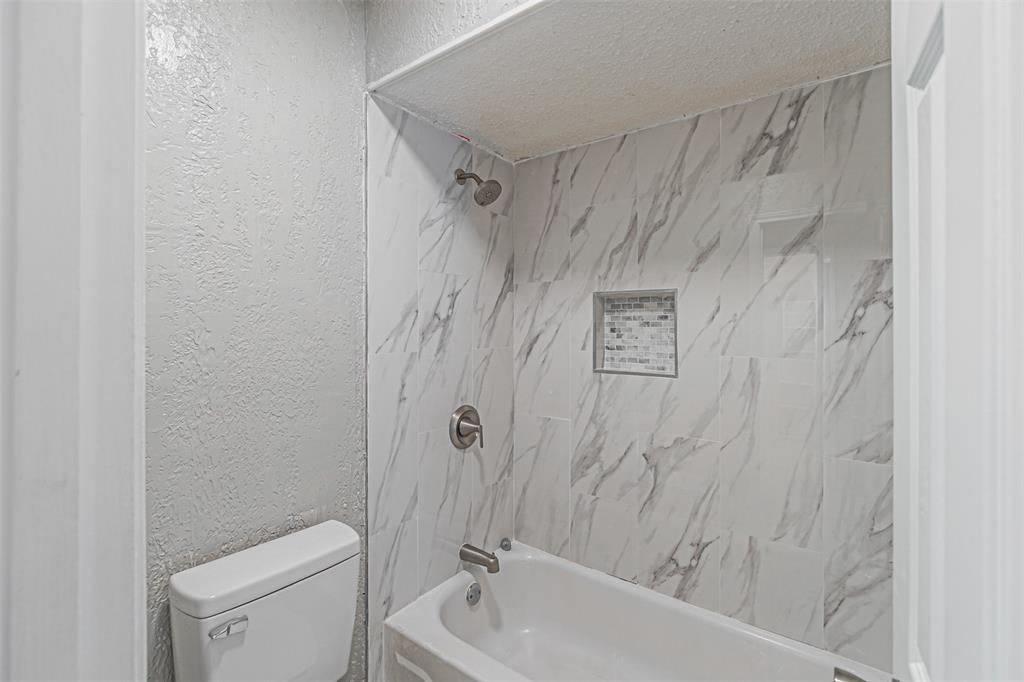 2435 Old Mill Road Dallas, TX 75287 - Photo 27 of 30 a bathroom with a shower a toilet and sink