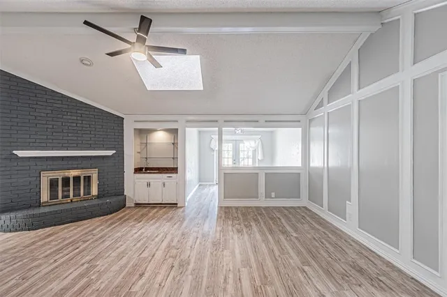 a view of a livingroom with wooden floor and a ceiling fan