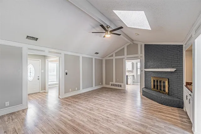 wooden floor in an empty room with a fireplace