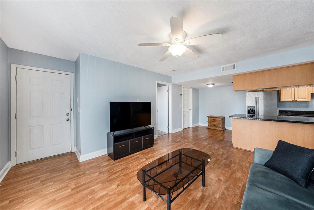 3711 West Iowa Avenue, Unit 214 Tampa, FL 33611 - Photo 12 of 29 a living room with furniture and a flat screen tv