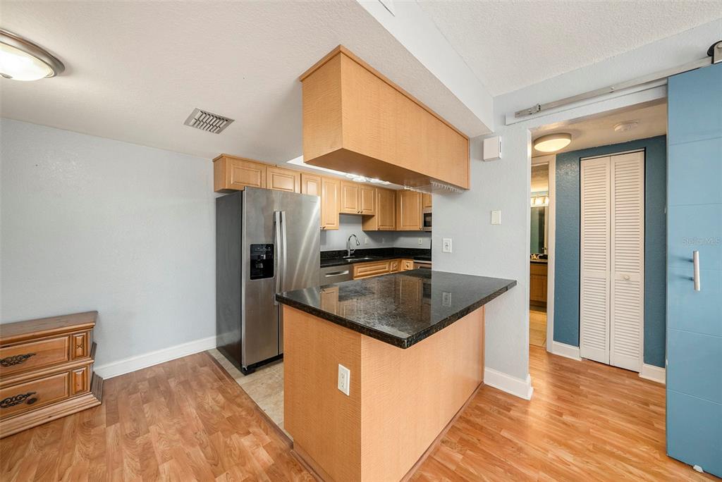 3711 West Iowa Avenue, Unit 214 Tampa, FL 33611 - Photo 13 of 29 a kitchen with stainless steel appliances granite countertop a sink and a refrigerator