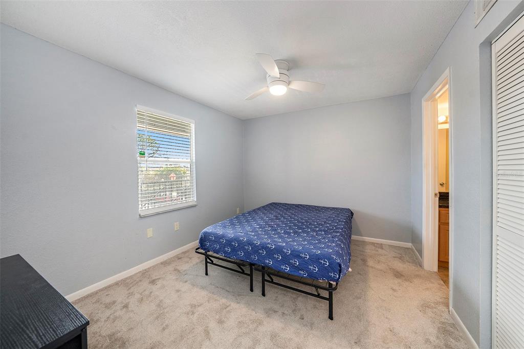 3711 West Iowa Avenue, Unit 214 Tampa, FL 33611 - Photo 15 of 29 a living room with a bed furniture and a window