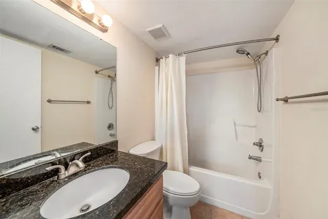 a bathroom with a sink toilet a mirror and shower