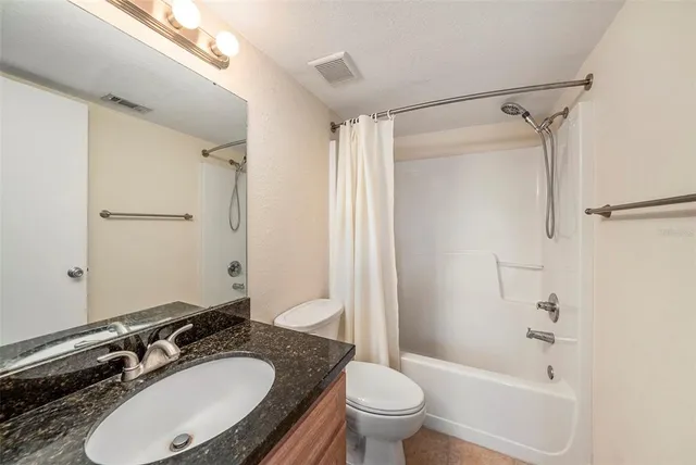 a bathroom with a sink toilet a mirror and shower