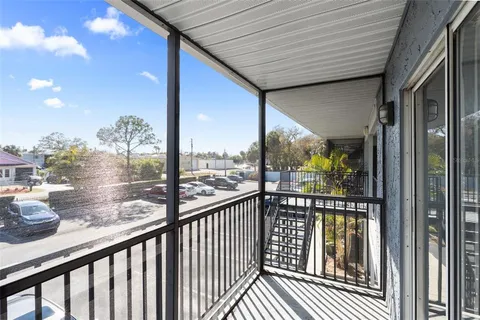 a view of a porch with a table and chairs