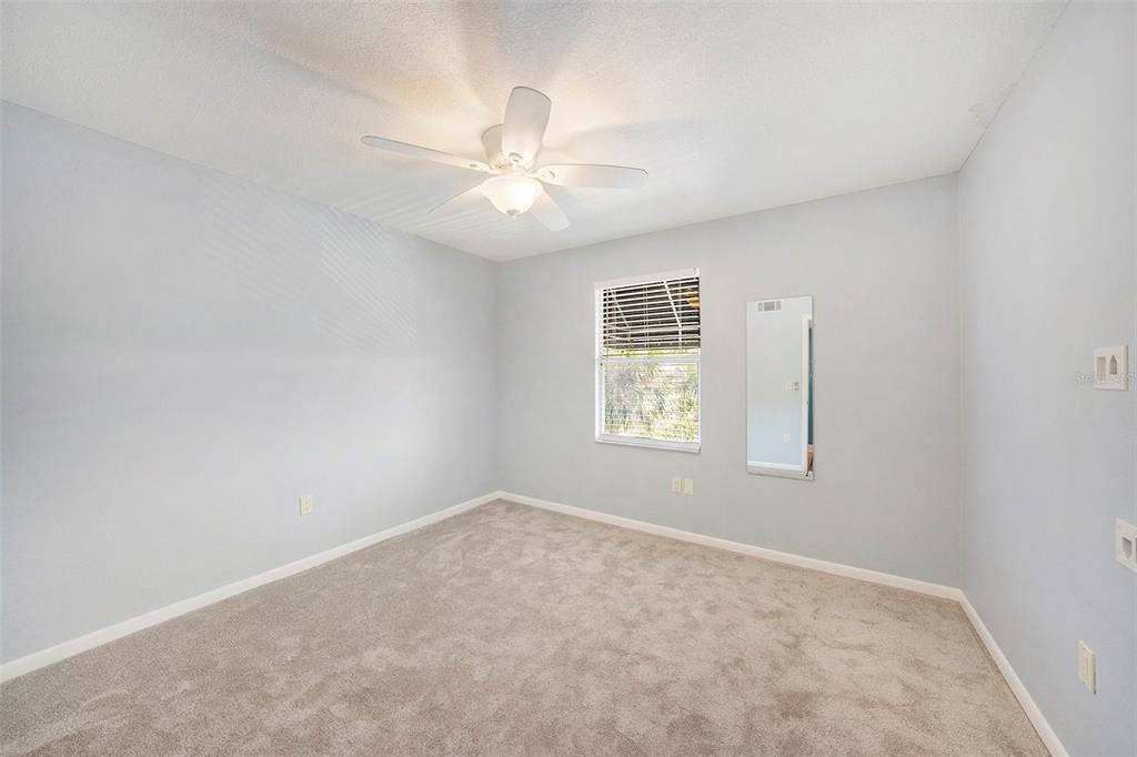 3711 West Iowa Avenue, Unit 214 Tampa, FL 33611 - Photo 19 of 29 an empty room with windows and fan