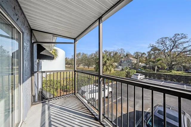 a view of balcony with wooden floor and fence