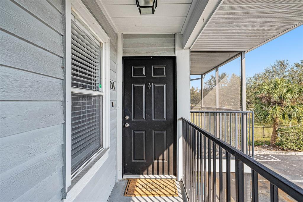 3711 West Iowa Avenue, Unit 214 Tampa, FL 33611 - Photo 26 of 29 a view of balcony with wooden floor and fence