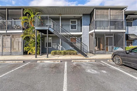 a view of a house with a patio and a car parked
