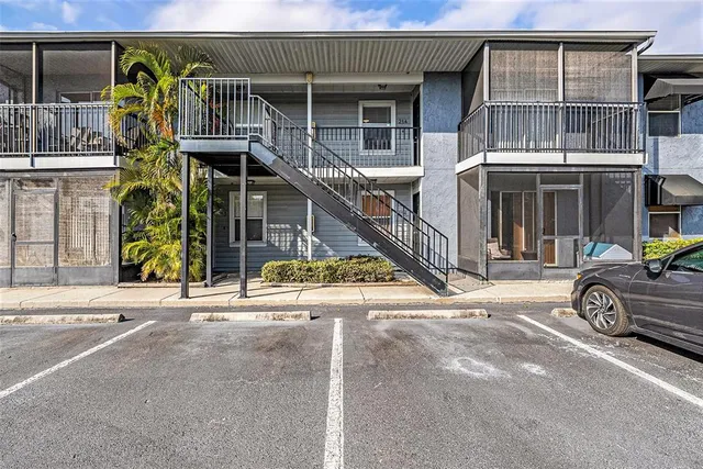 a view of a house with a patio and a car parked