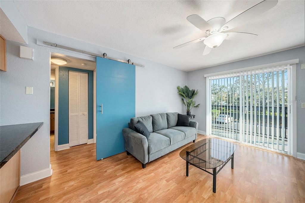 3711 West Iowa Avenue, Unit 214 Tampa, FL 33611 - Photo 6 of 29 a living room with furniture and a large window