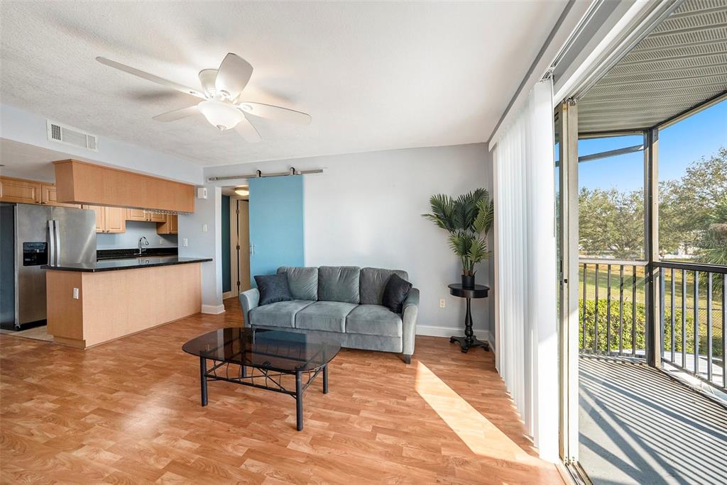 3711 West Iowa Avenue, Unit 214 Tampa, FL 33611 - Photo 7 of 29 a living room with furniture and a flat screen tv